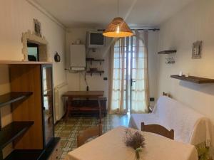 a living room with a couch and a table at Casa con giardino in Lido delle Nazioni