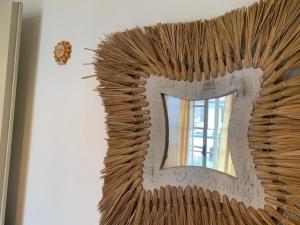 a large mirror with a letter on a wall at Casa con giardino in Lido delle Nazioni