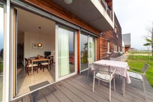 a patio with a table and chairs on a deck at Apartment Vitus in Cermes