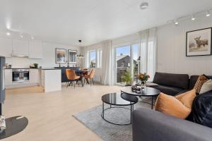 a living room with a couch and a table at Modern apartment in Elverum in Elverum