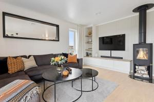 a living room with a couch and a fireplace at Modern apartment in Elverum in Elverum
