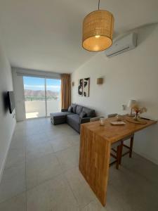 a living room with a couch and a table at Monte Paraíso Beach in Puerto Rico de Gran Canaria
