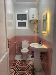 a bathroom with a toilet and a sink at Wide Seaview 3-Bedroom Apartment in Alexandria