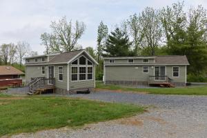 a house and a home with a yard at Hershey Camping Resort Loft Park Model 7 in Mount Wilson