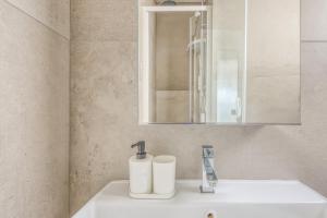a bathroom with a sink and a mirror at Chez Emilien in Bordeaux +30 photos