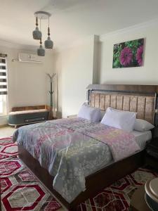 a bedroom with a large bed and a rug at Wide Seaview 3-Bedroom Apartment in Alexandria