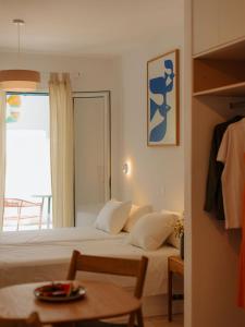 a hotel room with a bed and a window at Adelfia Studios in Parikia