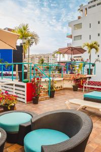 a patio with chairs and tables and a water park at La Iguana Vallarta LGBT ADULTS ONLY - Romantic Zone - Party Clubbing Street in Puerto Vallarta