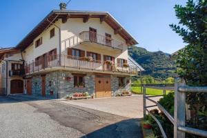 a large house with a balcony on top of it at Agriturismo La Grange in Pont-Saint-Martin