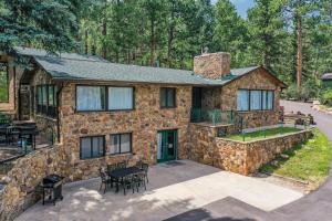 a stone house with a table and chairs in front of it at 4925 Pike in Cascade-Chipita Park