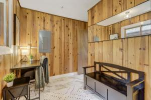 a room with a wooden wall with a bed and a desk at 4925 Pike in Cascade-Chipita Park