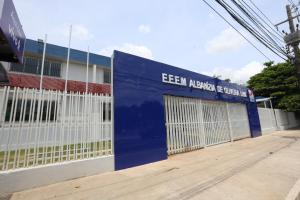 a building with a blue and white fence at Hostel Oficial COP30 in Belém