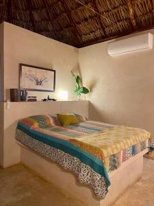 a bedroom with a bed in a room at Cabañas HUNAB KU 21 in Hocabá