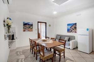 a kitchen and dining room with a table and chairs at Villa Azzurra in Massa Lubrense