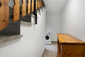 a laundry room with a washing machine and a staircase at Luéisch Ketschu near Gressoney in Issime +39 photos