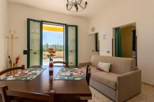 a living room with a table and a couch at The Rising Sun in Marinella di Selinunte