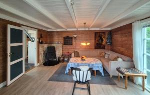 a living room with a table and a couch at Awesome Home In Skiftun With House Sea View in Nesvik