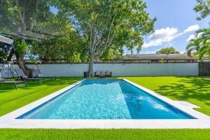 a swimming pool in the middle of a yard at CasaMia Only 10 min to Wynwood with New Pool, Bikes, Parking and Privacy in Miami