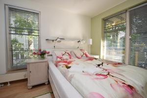a bedroom with a bed with pink flowers on it at Bright Home in Tallinn