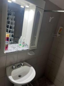 a bathroom with a sink and a mirror at Barrio el Trebol A1 in San Martín +14 photos