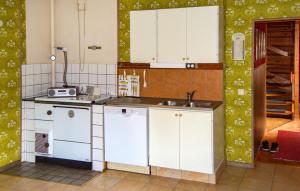 a kitchen with white cabinets and a sink at Lovely Home In Kopparberg With Sauna in Kopparberg