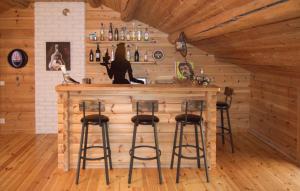 a bar in a log cabin with stools at Lovely Home In Kopparberg With Sauna in Kopparberg