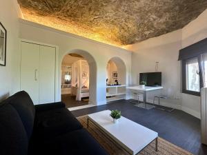 a living room with a couch and a table at Avalon in Setenil in Setenil