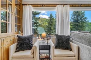 a living room with two chairs and a large window at 4925 Pike Unit1 in Cascade-Chipita Park