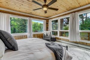 a bedroom with a large bed and windows at 4925 Pike Unit1 in Cascade-Chipita Park