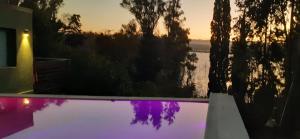 a view of a swimming pool at sunset at Vista Alago in Villa Ciudad Parque