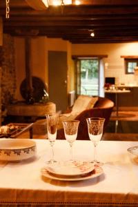 a table with two glasses and a plate of food at Charmant Moulin De Selves in Auriac