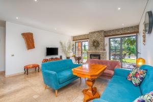 a living room with blue furniture and a fireplace at Quinta Dos 4 Ventos in Silves