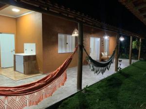 a hammock on the side of a house at Casa às margens do Rio Caraíva, área verde in Caraíva +25 photos