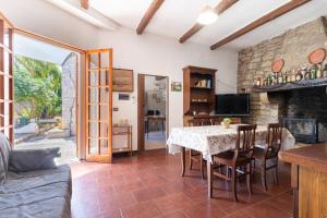 a living room with a table and a fireplace at Torre Cappavecchia in Molfetta