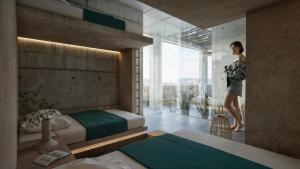 a woman is standing in a bedroom with two beds at Casa Arrecife in Talara