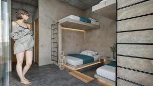 a woman standing in a room with bunk beds at Casa Arrecife in Talara