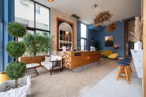 a lobby with a counter and chairs and tables at Invictus Hotel in Budva