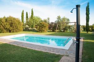 - une piscine dans une cour avec une balançoire dans l'établissement Le Gerlette - Il Granaio, à Braccagni
