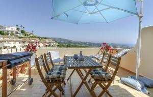 a table and chairs with an umbrella on a patio at Vistas a Moraira in Teulada
