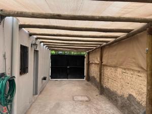 a garage with a large garage door with a tent over it at Barrio el Trebol A1 in San Martín