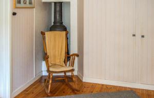 a wooden rocking chair sitting in a room at Pet Friendly Home In Kopparberg With Lake View in Kopparberg