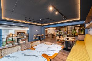 a room with tables and chairs and a library at Invictus Hotel in Budva