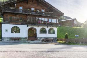 a large wooden house with a balcony on it at A Nett’s Nest in Hainzenberg
