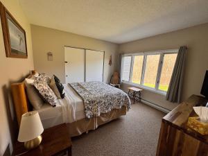 a bedroom with a bed and a window at Loon Mountain Retreat with Pool and Hot Tub in Lincoln +43 photos