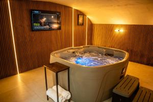 a large tub in a room with a tv at 10 Park Square East, Luxury Serviced Apartments in Leeds