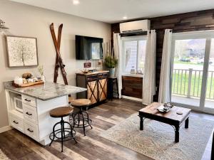 a kitchen with a counter and a table in a room at Loon Mountain Retreat with Pool and Hot Tub in Lincoln