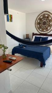 a bedroom with a bed with a hammock in it at Suíte Mykonos Canoa Quebrada- Ao lado da Broadway in Aracati