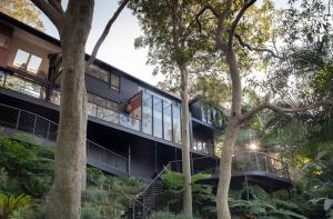 an external view of a building with trees at Crane Lodge in Whale Beach