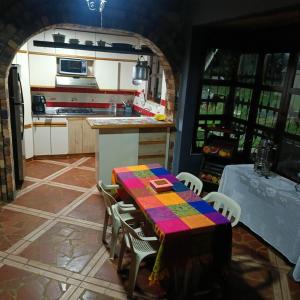 a kitchen with a table and chairs in a room at Finca 5 Continentes - Cerca MatroCable ARVI in Guarne +22 photos