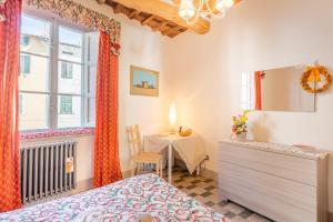 a bedroom with a table and a bed and a window at Mangiafuoco in Collodi